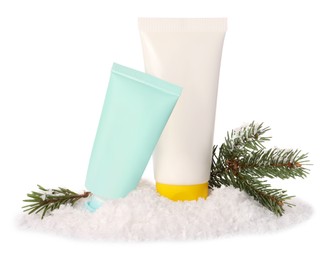Photo of Tubes of hand cream and Christmas decor isolated on white. Winter skin care