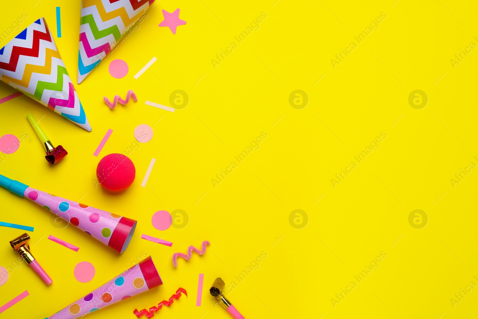 Photo of Flat lay composition with party items on yellow background, space for text