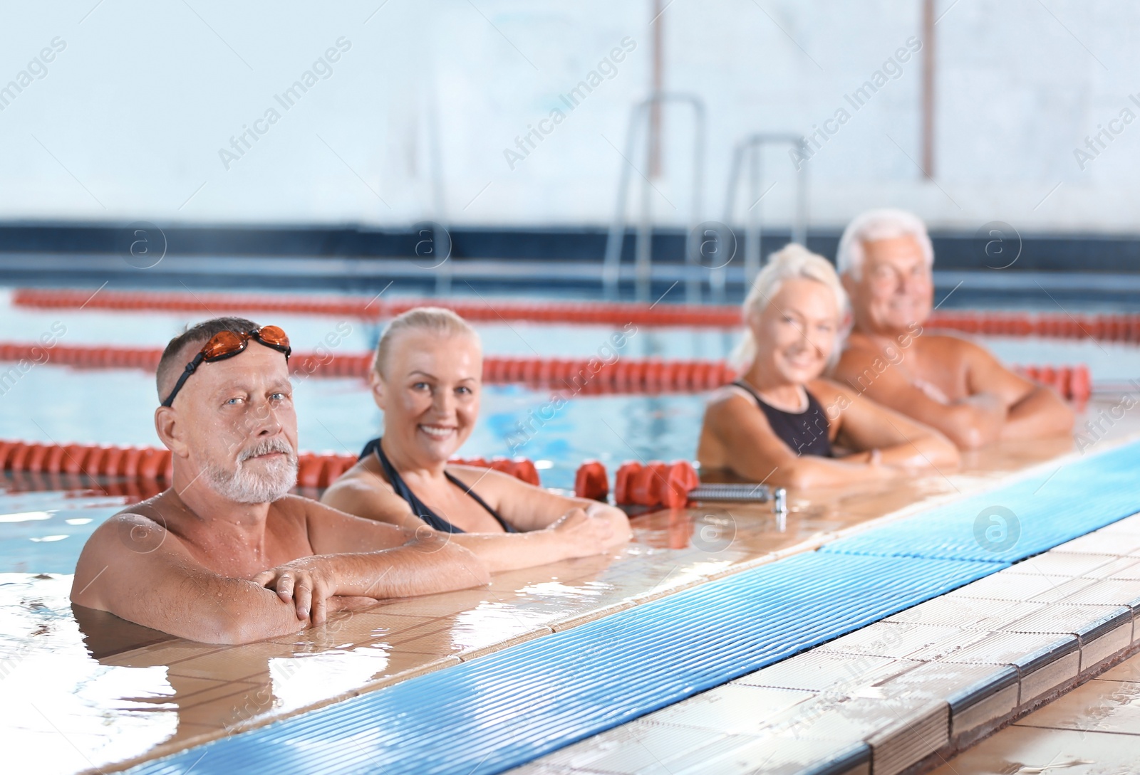 Photo of Sportive senior people in indoor swimming pool