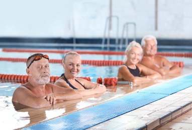 Photo of Sportive senior people in indoor swimming pool