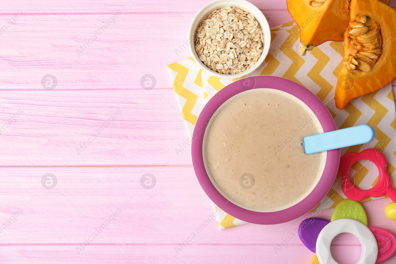 Photo of Flat lay composition with plate of healthy baby food and space for text on color background