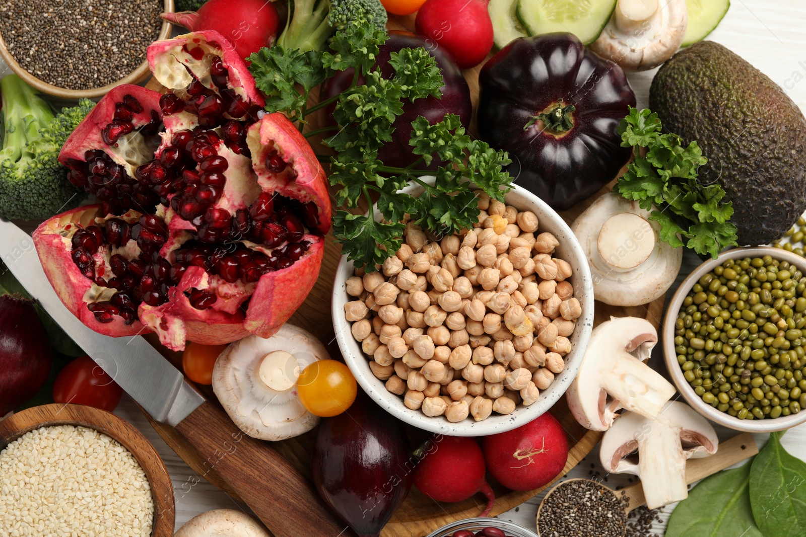 Photo of Different vegetables on white wooden table, flat lay. Vegan diet