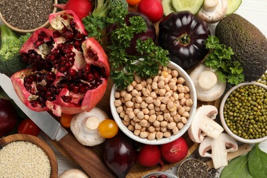 Different vegetables on white wooden table, flat lay. Vegan diet