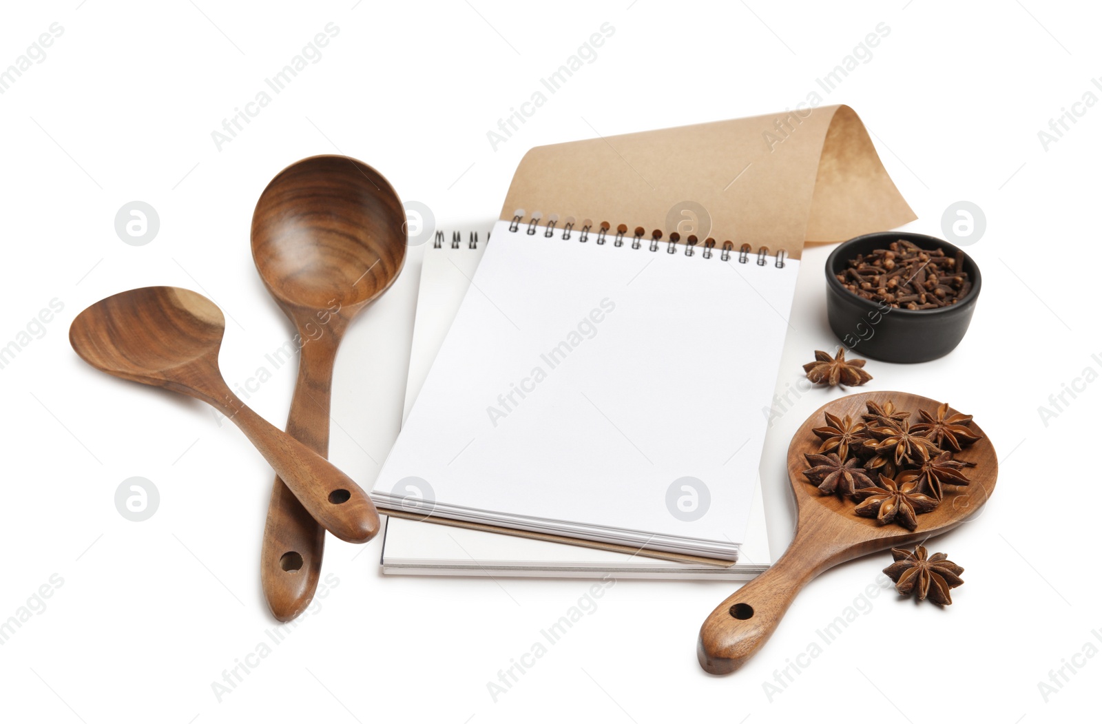 Photo of Blank recipe book, spices and wooden utensils on white background. Space for text