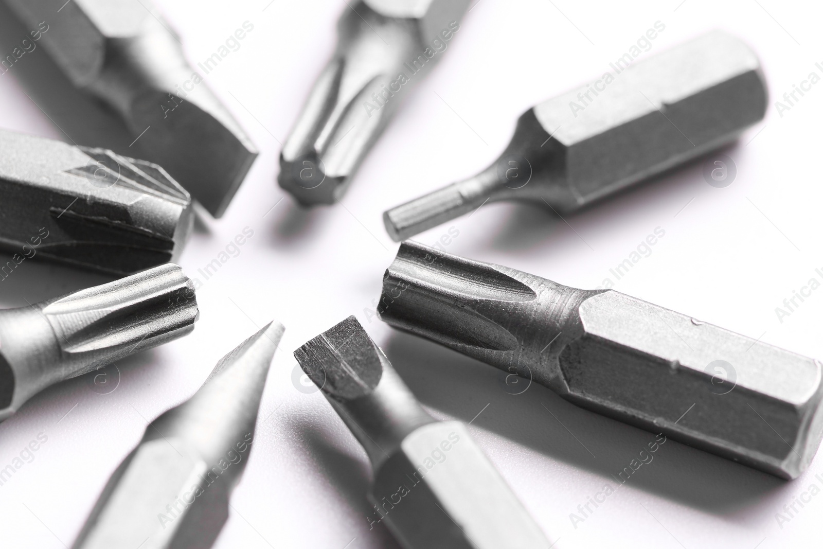 Photo of Different screwdriver bits on white background, closeup