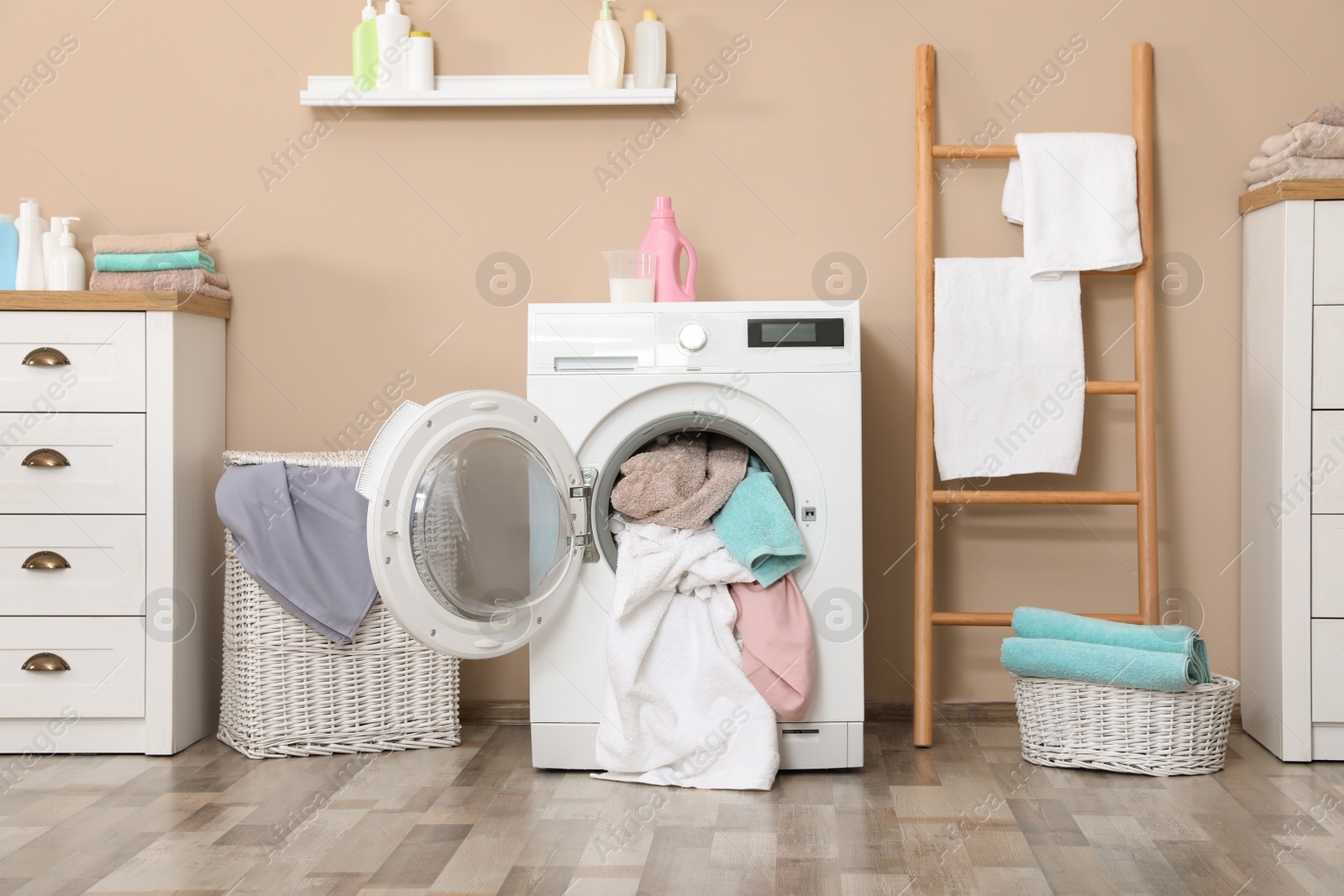 Photo of Bathroom interior with dirty towels in washing machine