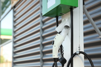 Photo of Electric vehicle charging station outdoors, space for text. Modern technology