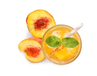 Photo of Peach cocktail in glass and fresh fruit on white background, top view