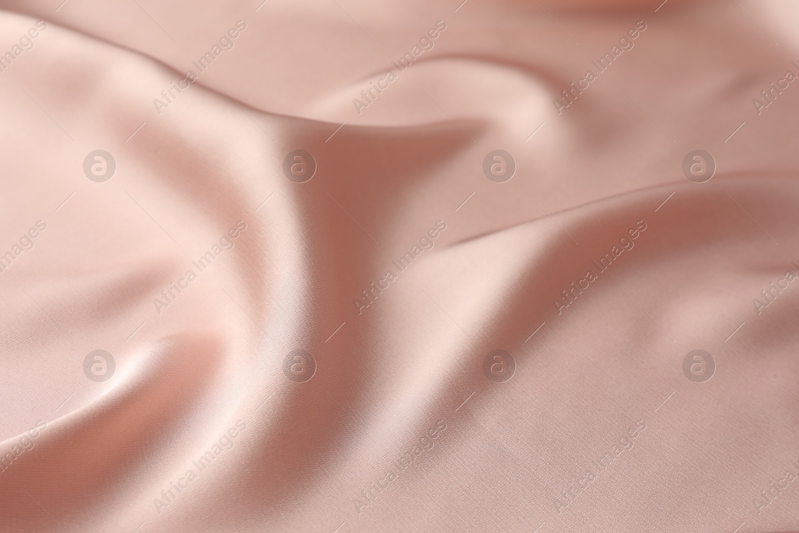 Photo of Crumpled pink silk fabric as background, closeup