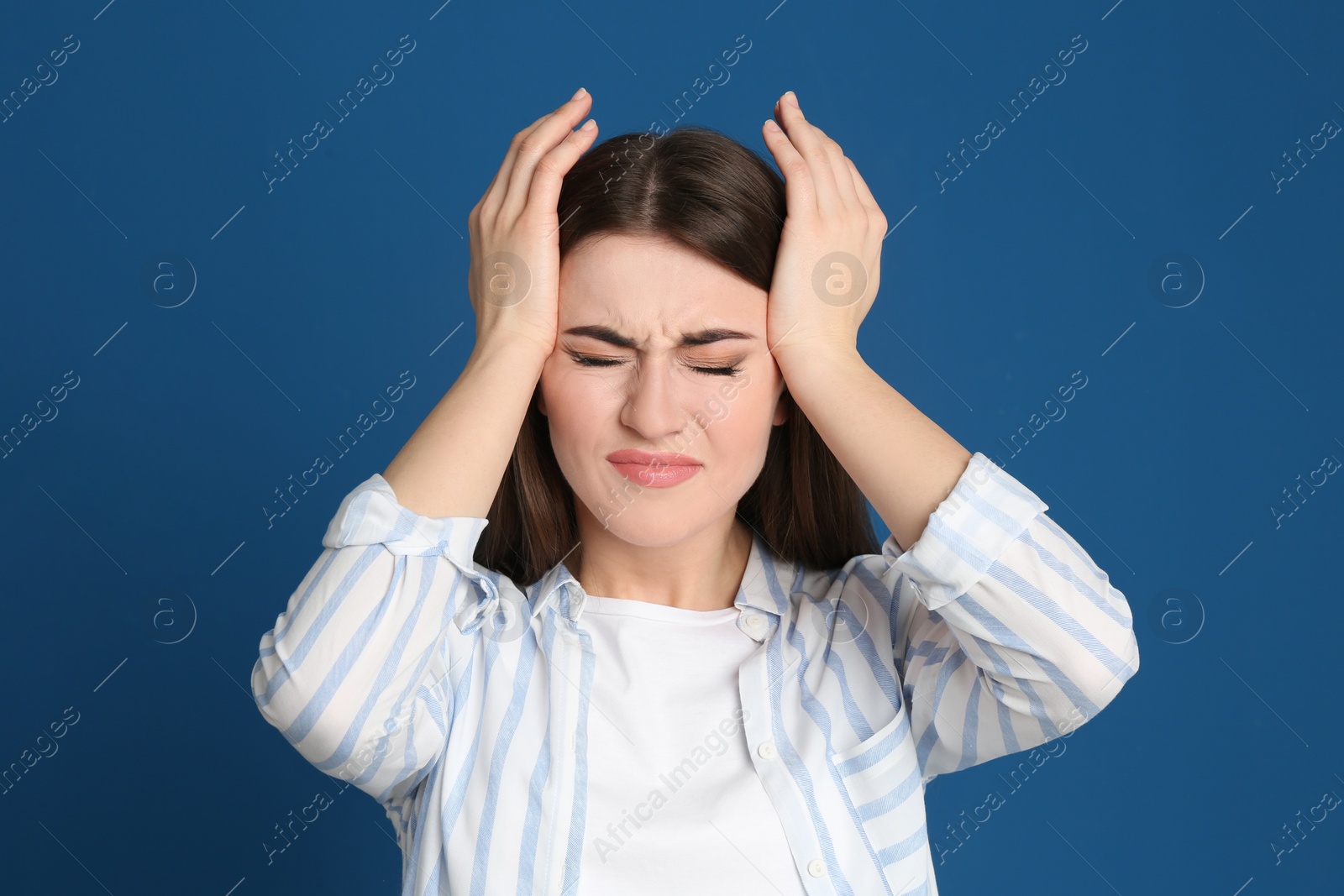 Photo of Portrait of emotional young woman on blue background