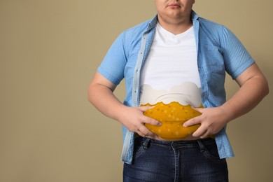 Beer belly problem. Overweight man on beige background, closeup