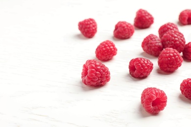 Photo of Ripe aromatic raspberries on table, closeup