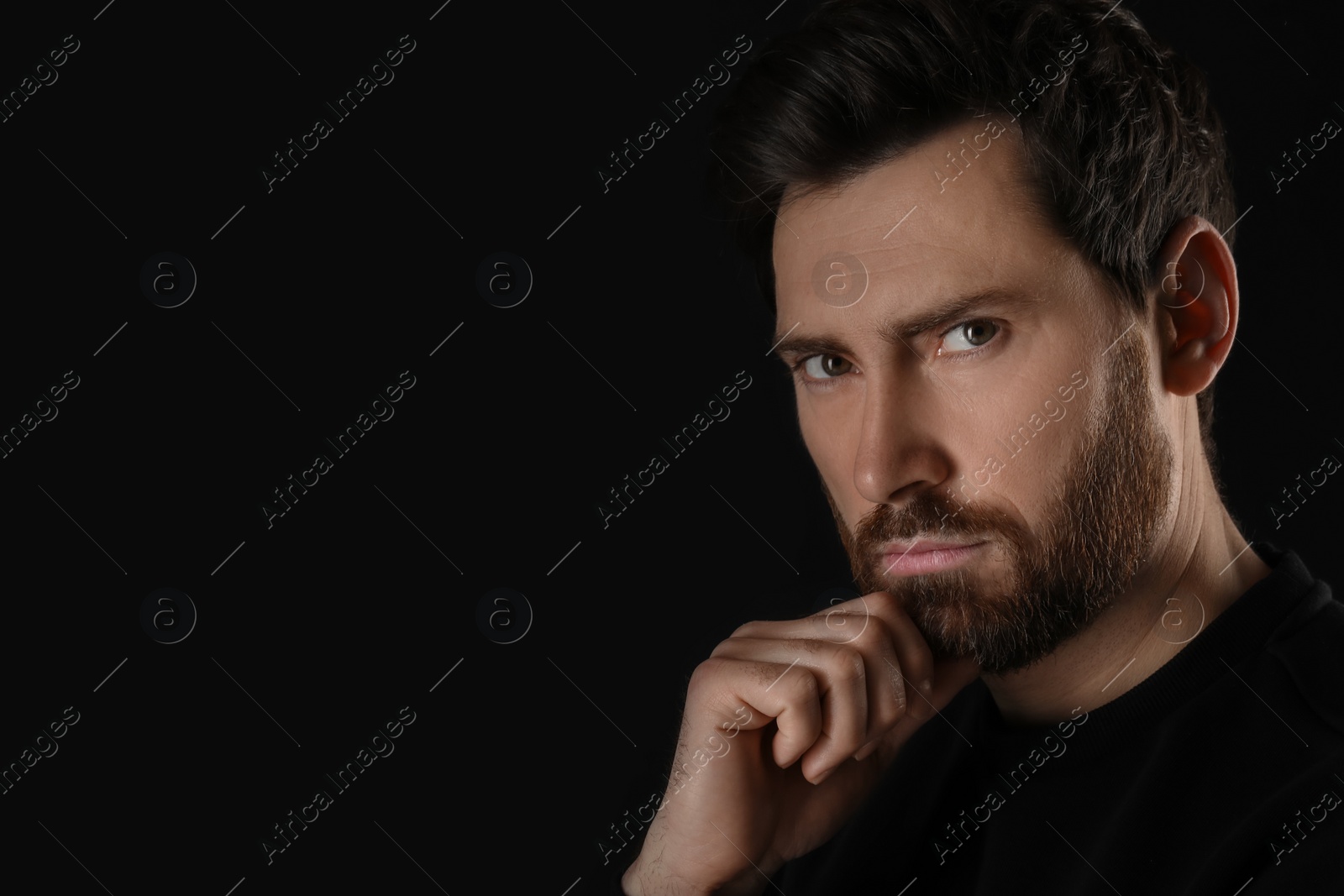 Photo of Evil eye. Man with scary eyes on black background, closeup and space for text