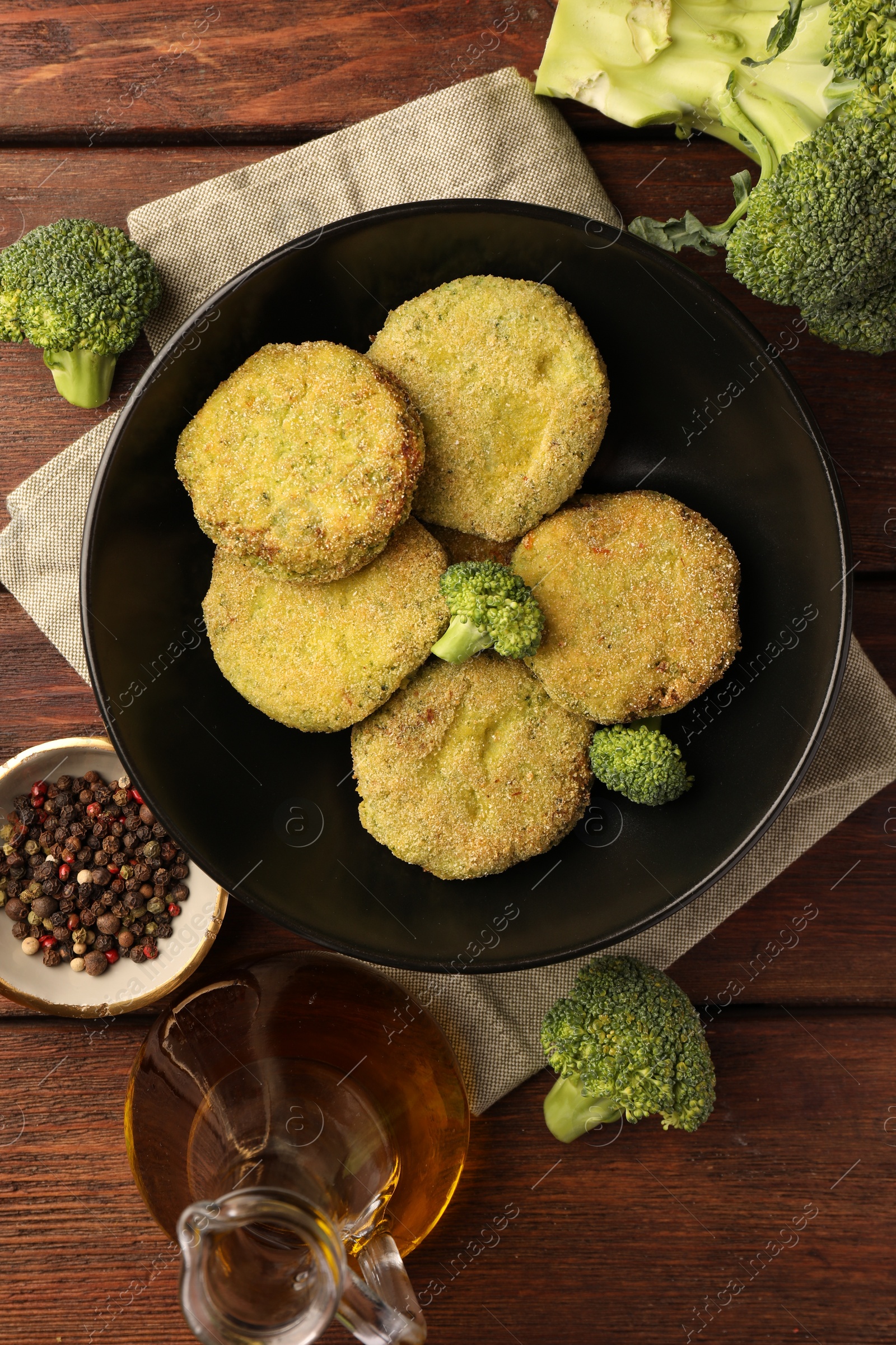 Photo of Tasty vegan cutlets and ingredients on wooden table, flat lay