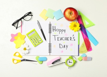 Flat lay composition with stationery and words TEACHER'S DAY on white background