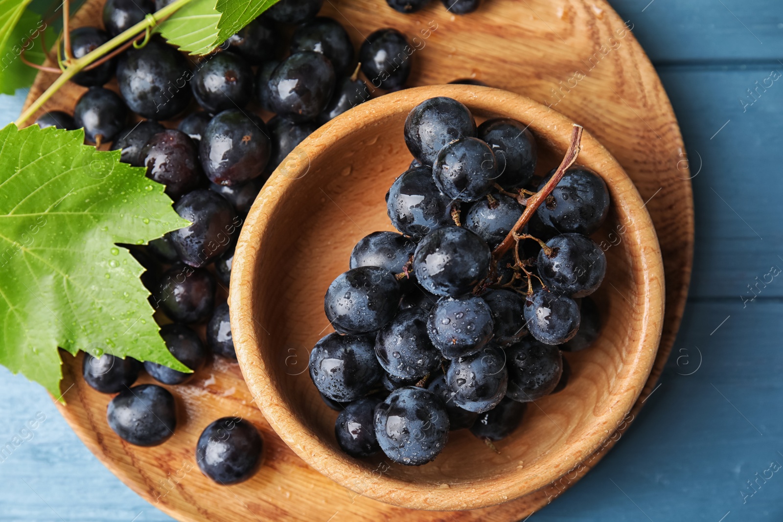 Photo of Flat lay composition with fresh ripe juicy grapes on wooden background