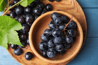 Flat lay composition with fresh ripe juicy grapes on wooden background