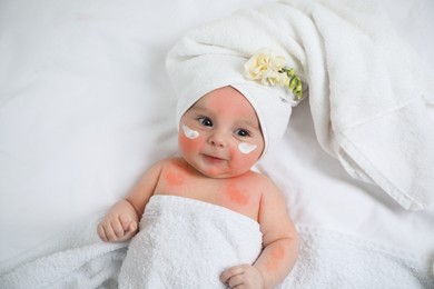 Image of Cute little baby with anti-allergic cream on cheeks, top view. Redness on skin