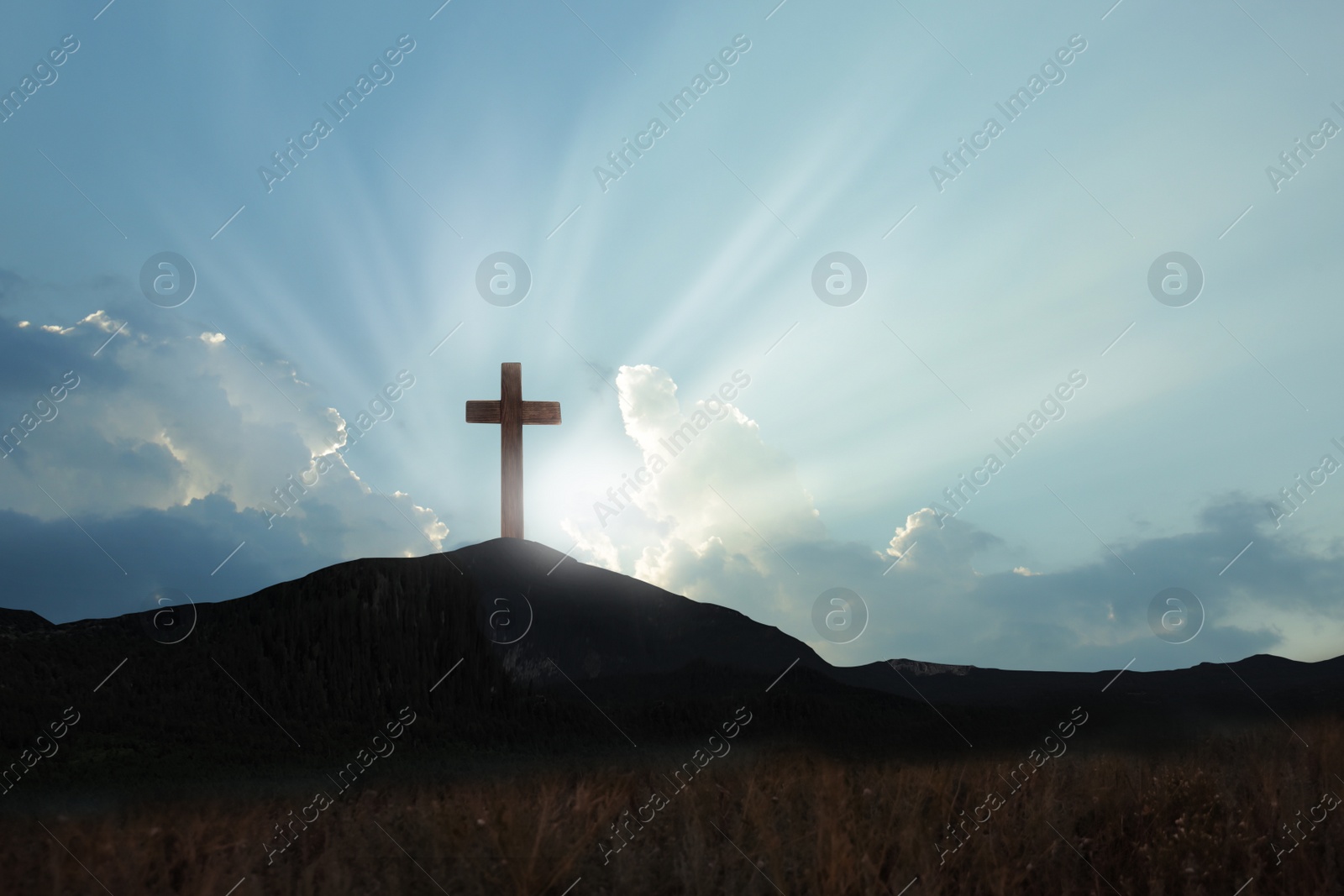 Image of Christian cross on hill outdoors at sunrise. Resurrection of Jesus