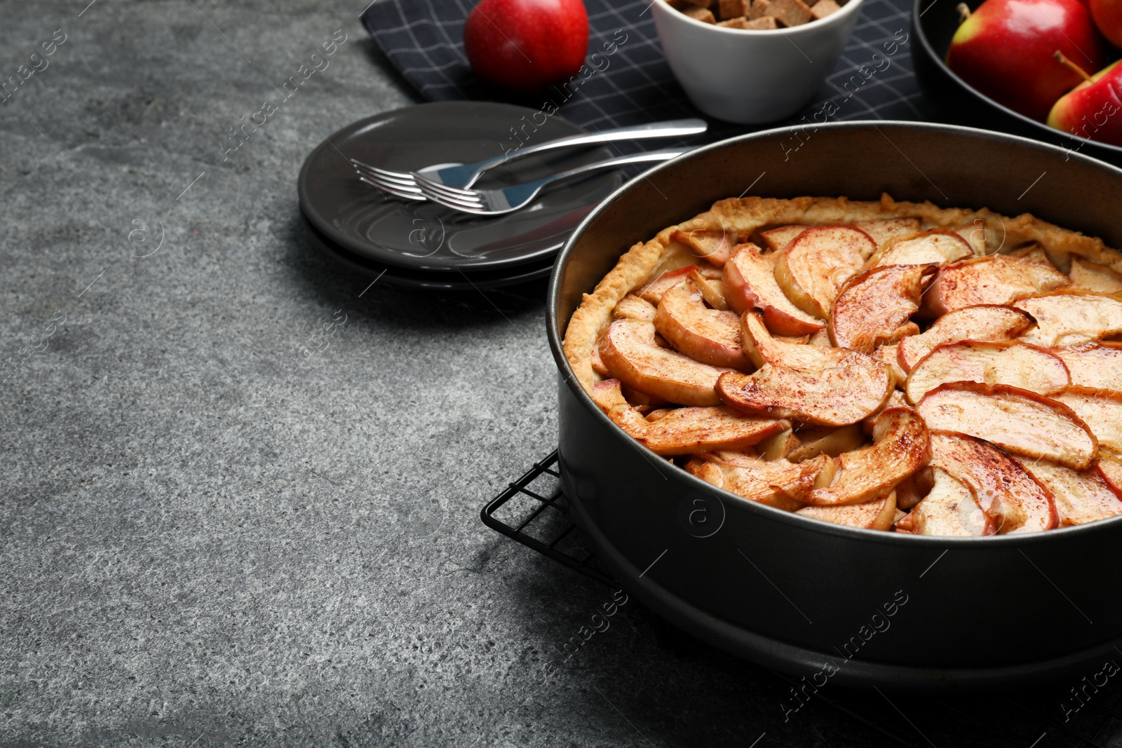 Photo of Delicious apple pie on grey table, space for text