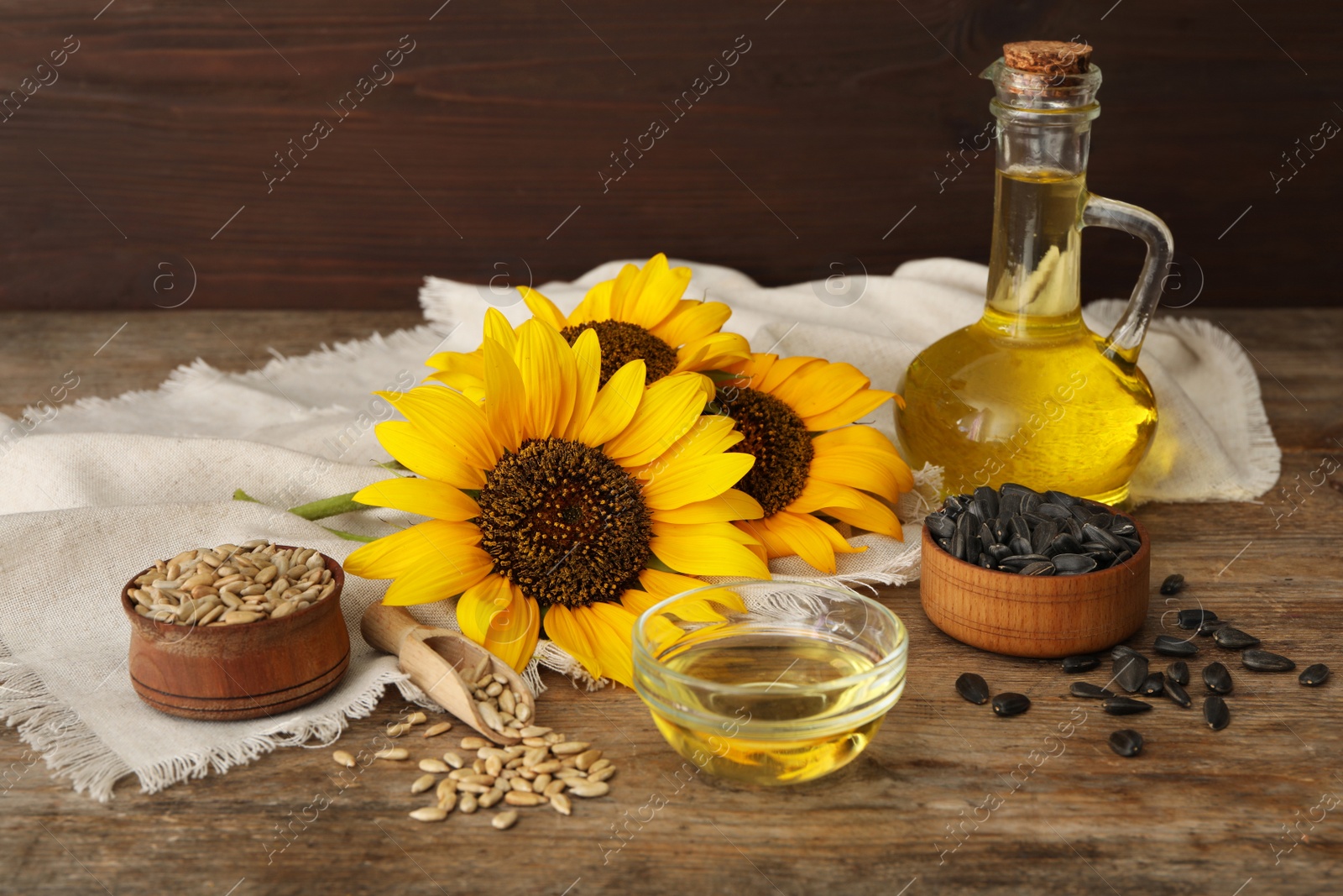 Photo of Composition with sunflower oil on wooden table