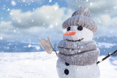 Image of Funny snowman outdoors on sunny day, space for text