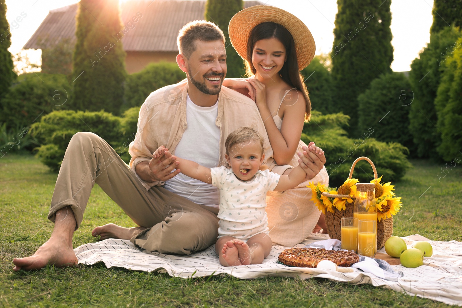 Photo of Happy family having picnic in garden on sunny day