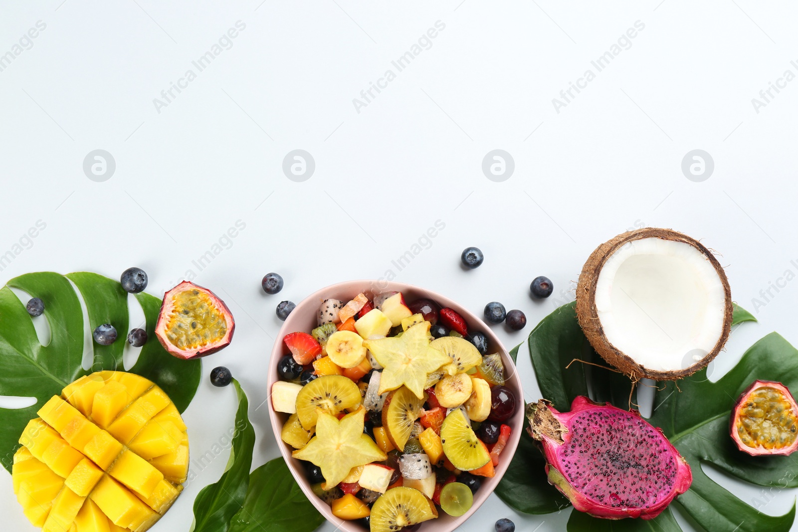 Photo of Composition with delicious exotic fruit salad on white background, top view