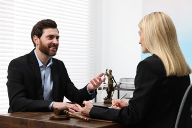 Photo of Man having meeting with lawyer in office