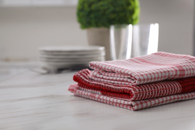 Photo of Dry kitchen towels on white marble table. Space for text