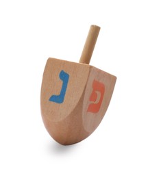Photo of Wooden dreidel isolated on white. Traditional Hanukkah game