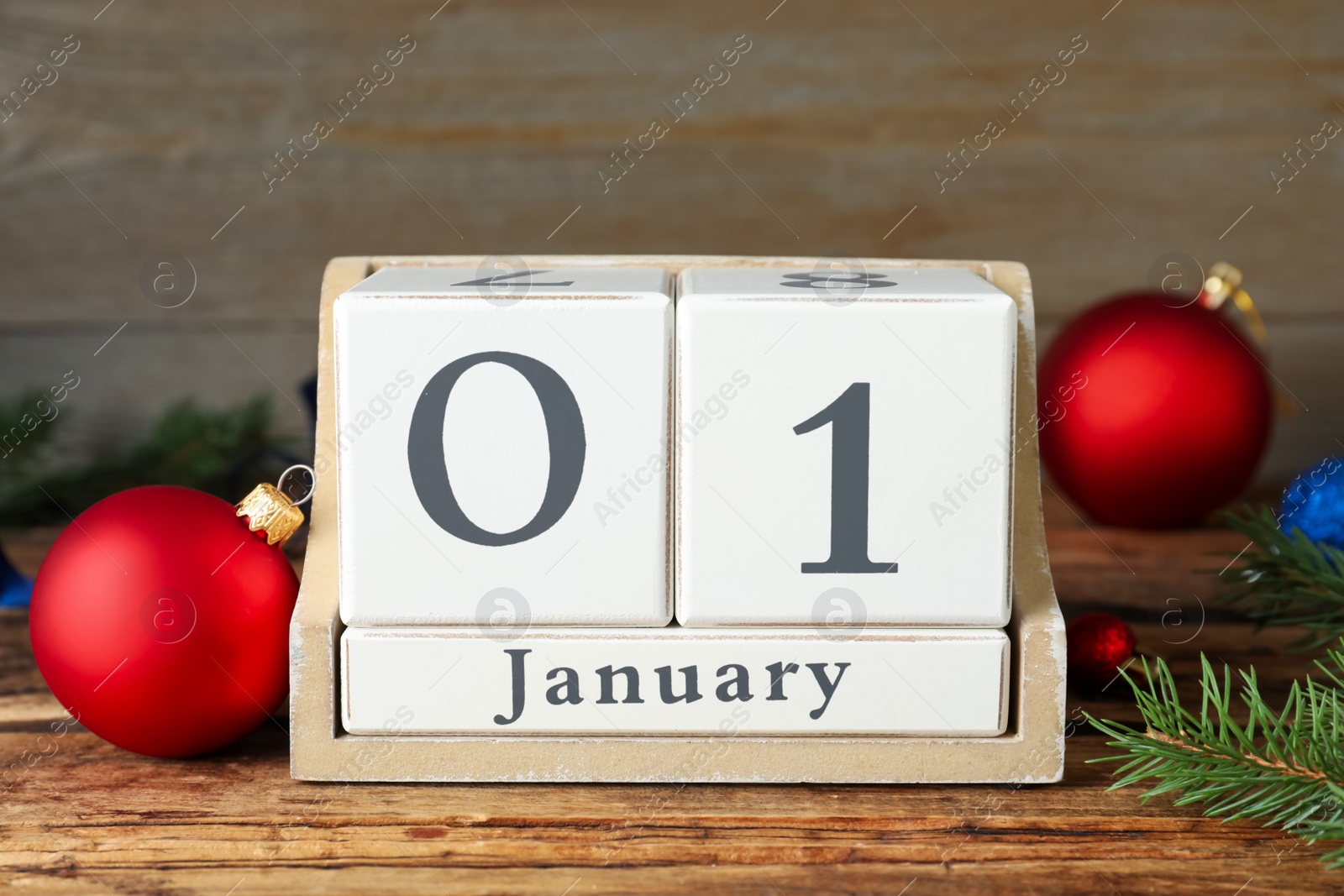 Photo of Wooden block calendar and Christmas decor on table. New Year celebration