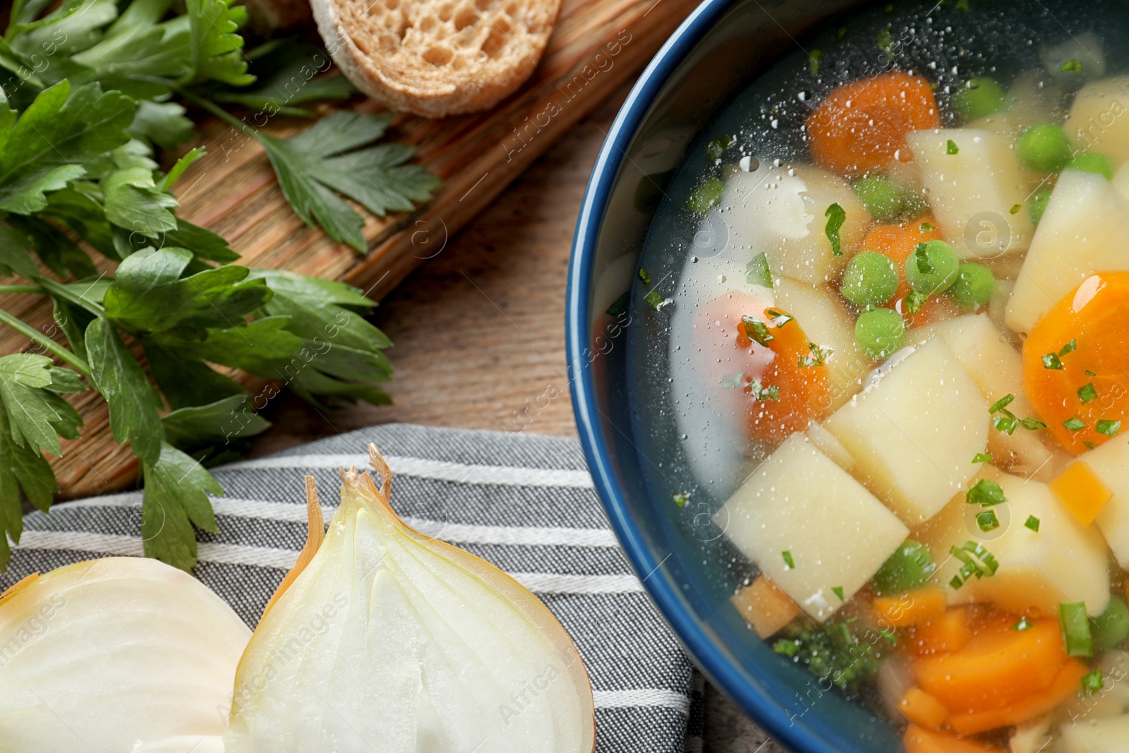 Photo of Bowl of fresh homemade vegetable soup served on table, top view