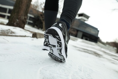 Man running in winter park, closeup. Outdoors sports exercises