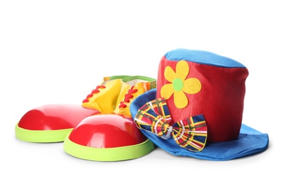 Photo of Clown shoes, bow and hat on white background