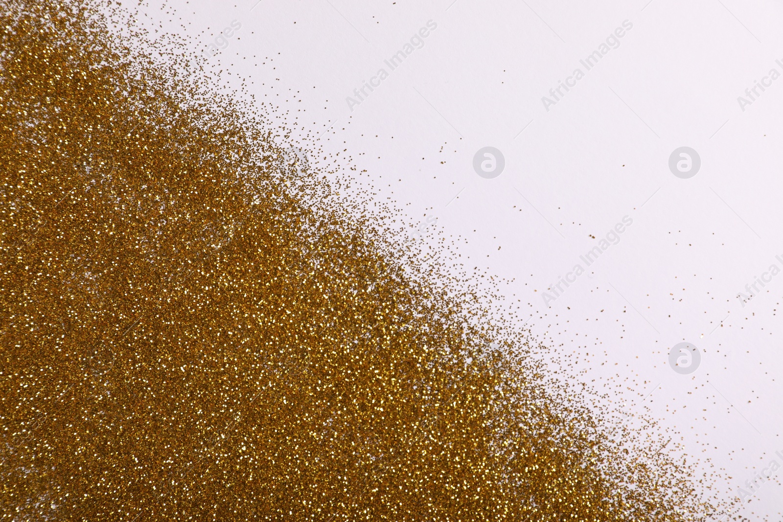 Photo of Shiny golden glitter on white background, top view