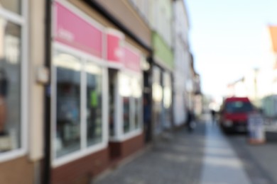 Blurred view of store exterior and city street. Bokeh effect