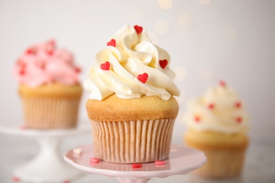 Photo of Tasty sweet cupcake on stand, closeup. Happy Valentine's Day