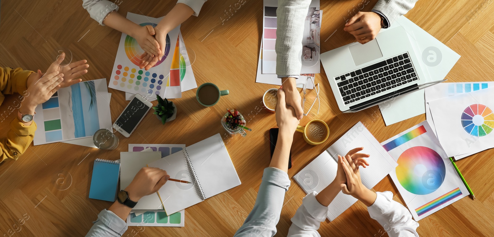 Photo of Team of professional designers working together at table, top view