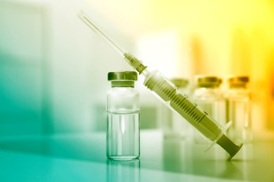 Image of Syringe and vial of medicine on table, closeup