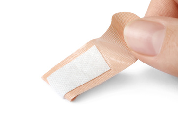 Photo of Woman putting sticking plaster on white background. First aid item