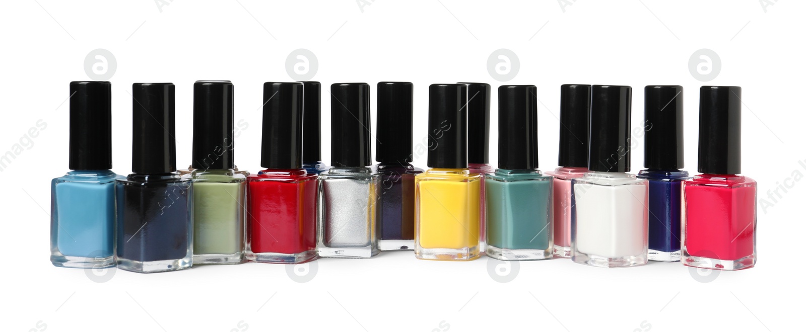 Photo of Bright nail polishes in bottles isolated on white
