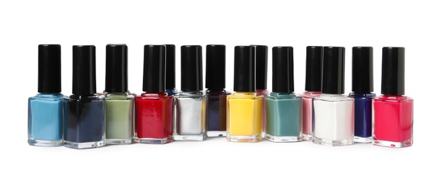 Bright nail polishes in bottles isolated on white