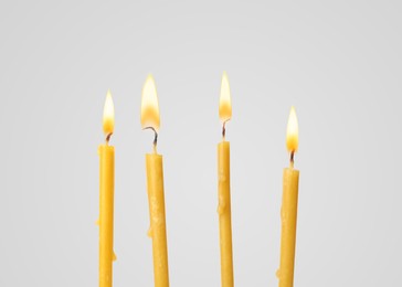 Image of Many burning church candles on light background