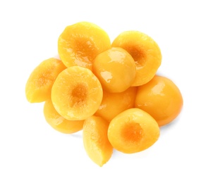 Halves of canned peaches on white background, top view