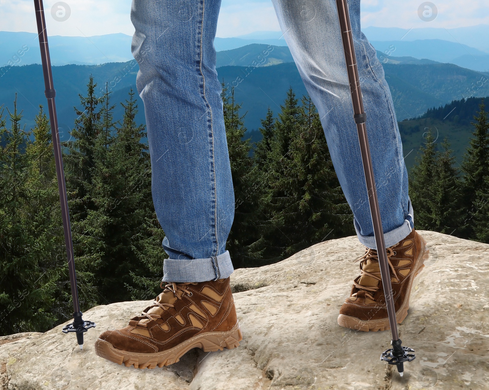 Image of Man with trekking poles in mountains on sunny day, closeup