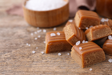 Delicious salted caramel on wooden table, closeup