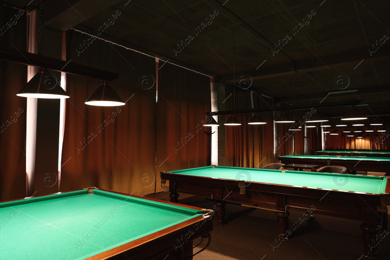 Photo of Empty green billiard tables in club. Pool Game