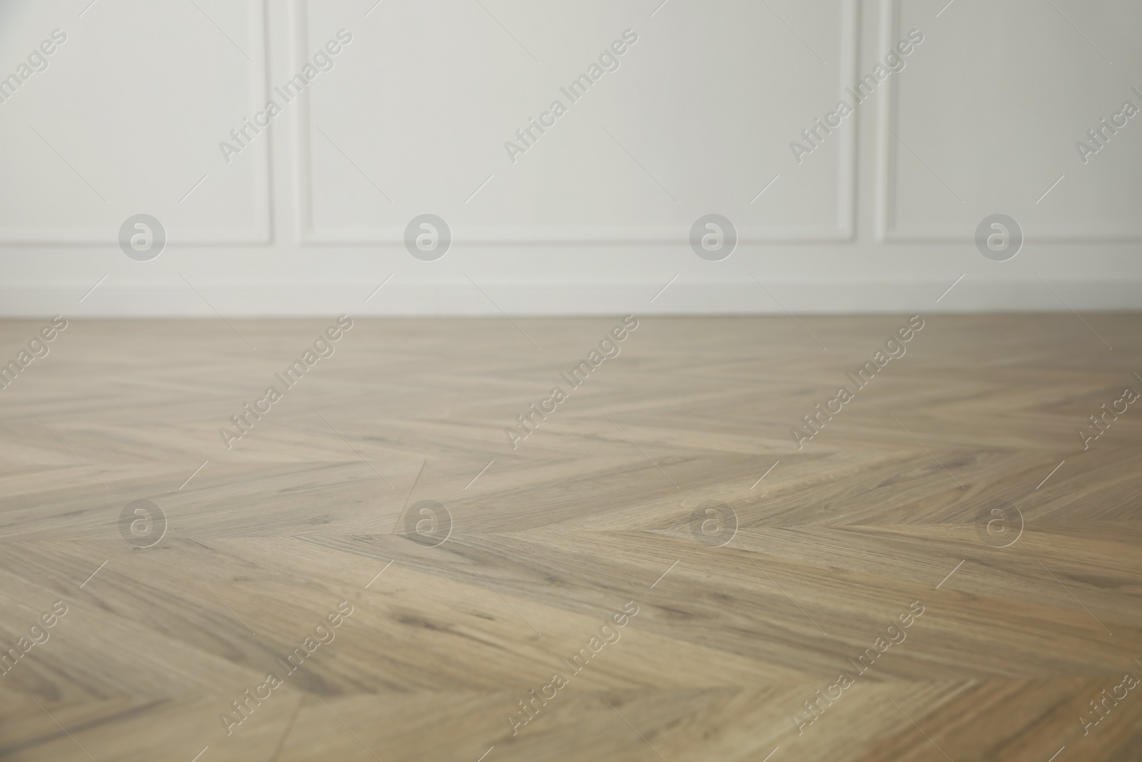 Photo of Parquet floor in light spacious empty room