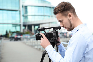 Video operator with camera working on city street